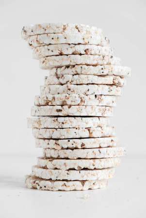 Round diet crispbreads on a white background. Round shaped cereal bread, healthy food without yeast. Copy, empty space for text.の写真素材
