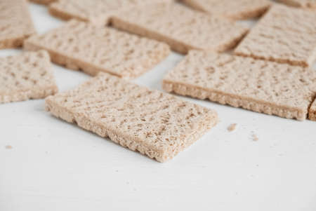 Rye crisp bread on a white wooden background. Top view. Copy, empty space for text.の写真素材