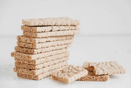 Stacked rye crisp bread on a white wooden background. Copy, empty space for text.の写真素材