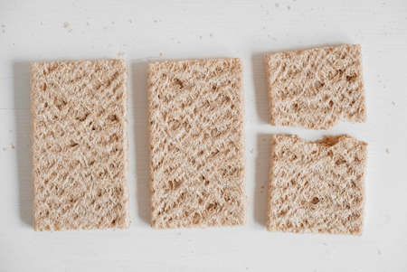 Rye crisp bread on a white wooden background. Top view. Copy, empty space for text.の写真素材