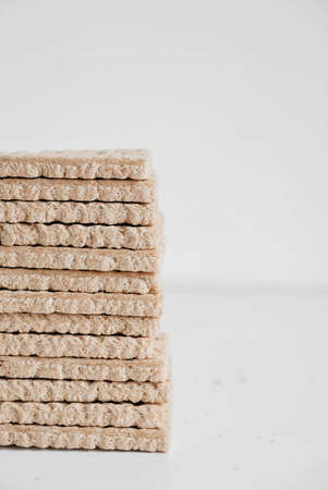 Stacked buckwheat crisp bread on a white wooden background. Copy, empty space for text.の写真素材