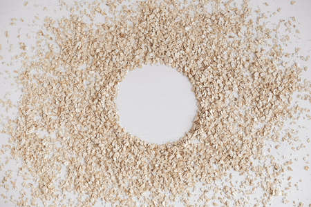 Dry oatmeal scattered in the form of a circle on a white background. Top view. Copy, empty space for text.の写真素材