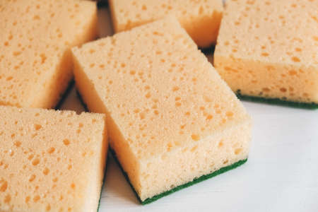 Yellow porous sponges on a white background. Top view. Copy, empty space for text.の写真素材