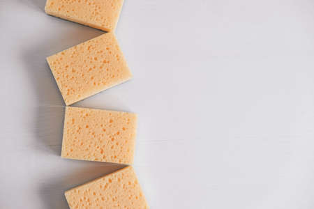 Yellow porous sponges on a white background. Top view. Copy, empty space for text.の写真素材