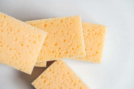 Yellow porous sponges on a white background. Top view. Copy, empty space for text.の写真素材