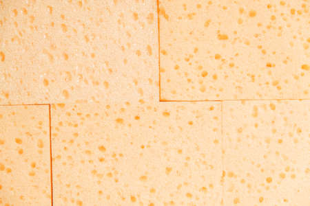 Texture of porous yellow sponges. Top view. Copy, empty space for text.の写真素材