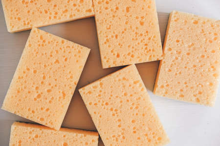 Yellow porous sponges on a white background. Top view. Copy, empty space for text.の写真素材
