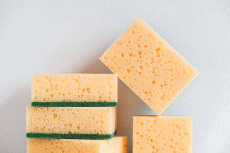 Yellow sponges on a white background. Copy, empty space for text.の写真素材