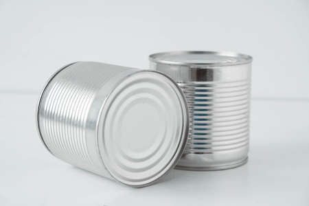Two aluminum closed metal cans on a white table. Copy, empty space for text.の写真素材
