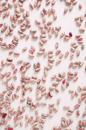 Dry beans are randomly scattered on a white table background. Top view. Copy, empty space for text.の写真素材