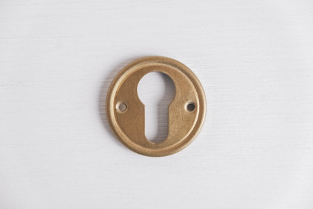 Metal keyhole on a white background. Top view. Copy, empty space for text.