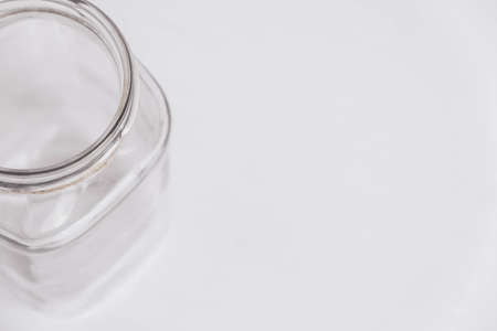 Glass transparent jar on a white table background. Copy, empty space for text.の写真素材