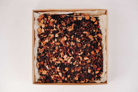 Dry fruit tea in a paper box on a white table background. Top view. Copy, empty space for text.の写真素材