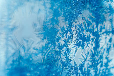 Ice patterns on frozen glass. Abstract ice pattern on winter glass as a background image. Copy, empty space for text.の写真素材