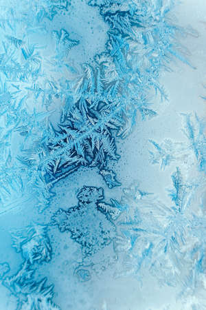 Ice patterns on frozen glass. Abstract ice pattern on winter glass as a background image. Copy, empty space for text.の写真素材