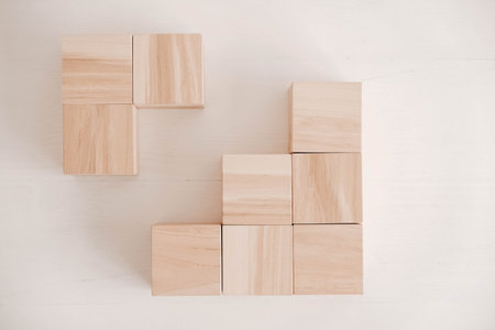 Stack wooden blocks from natural wood on a white background. Top view. Copy, empty space for text.の写真素材