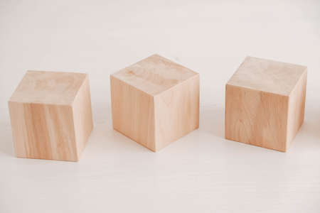Three wooden blocks from natural wood on a white background. Copy, empty space for text.の写真素材