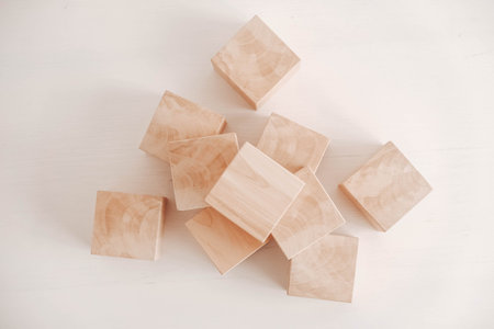 Stack wooden blocks from natural wood on a white background. Top view. Copy, empty space for text.
