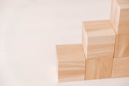 Stack wooden blocks from natural wood on a white background. Copy, empty space for text.