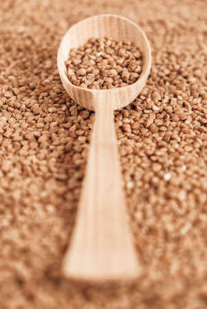 Buckwheat in a wooden spoon on a background of cereals. Copy, empty space for text.の写真素材