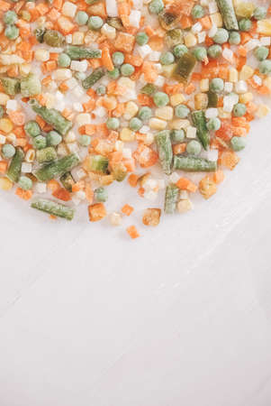 Mix of frozen vegetables on white background. Top view. Copy, empty space for text.の写真素材