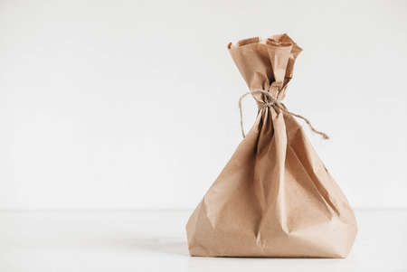 Full disposable bag of brown kraft paper on a white background. Copy, empty space for text.の写真素材