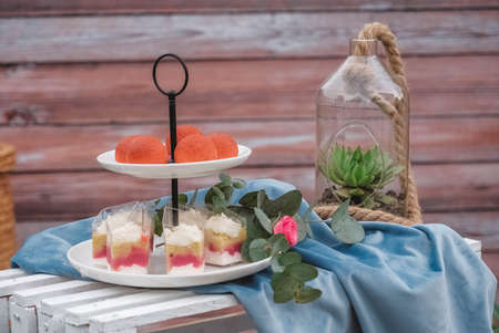 Banquet dessert table decorated in a rustic style decorated with plates, cutlery, glasses, candles and flower arrangements. Top view. Copy, empty space for text.の写真素材