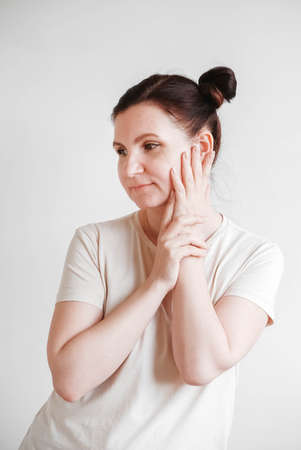 Woman with pigtails and a funny face wearing a T-shirt on a white background. Copy, empty spaceの写真素材