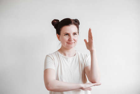 Woman with pigtails and a funny face wearing a T-shirt on a white background. Copy, empty spaceの写真素材