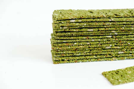 Crispy chips with kelp and spirulina on a white background.の写真素材