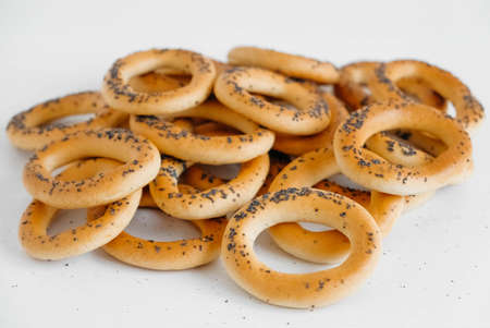 Dried bagels with poppy seeds on a white background.の写真素材