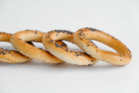 Dried bagels with poppy seeds on a white background.