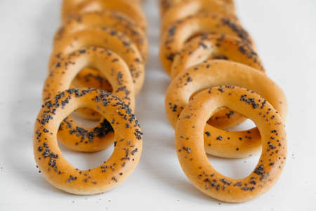 Dried bagels with poppy seeds on a white background.の写真素材