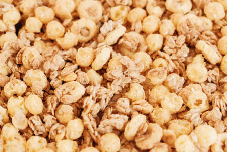 Dry muesli with cornflakes, nuts and raisins as texture backgroundの写真素材