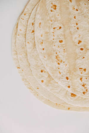 Thin pita bread on a white wooden table backgroundの写真素材