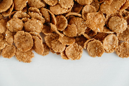 Crispy healthy dry cereal flakes on white background.