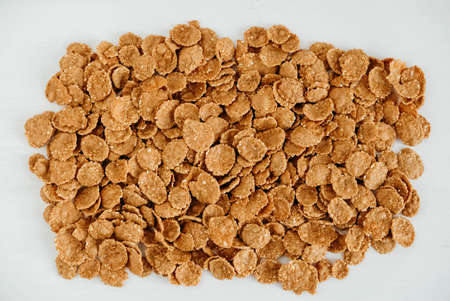 Crispy healthy dry cereal flakes on white background.の写真素材