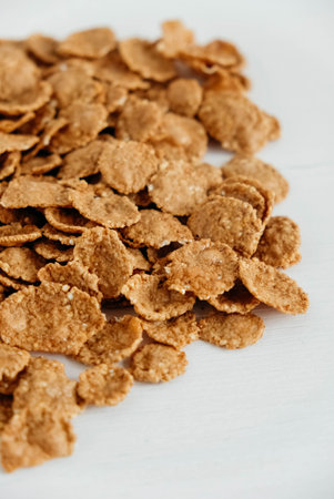 Crispy healthy dry cereal flakes on white background.