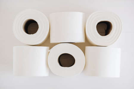Rolls of white toilet paper on a white background.の写真素材