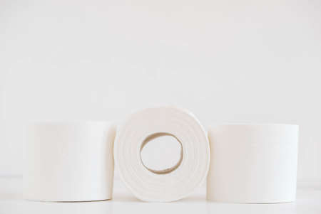 Rolls of white toilet paper on a white background.の写真素材