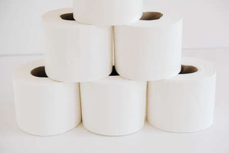 Rolls of white toilet paper on a white background.の写真素材