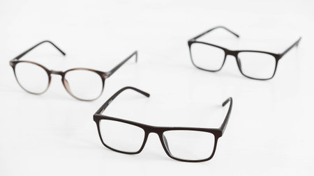 Three optical glasses of different shapes on a white background.