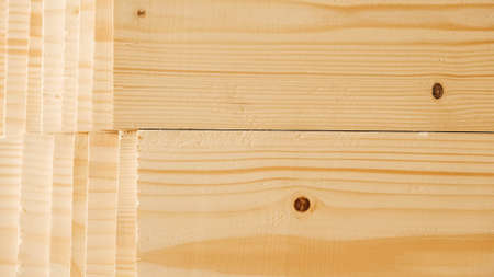 Stacked wooden carpentry boards from natural wood in a woodworking industry.の写真素材