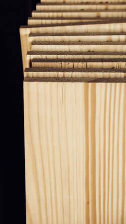 Stacked wooden carpentry boards from natural wood in a woodworking industry.