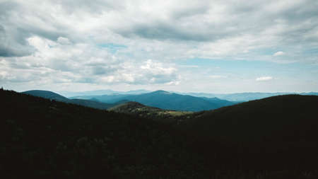 Green mountains of Carpathians in the middle of forest against background of a dramatic sky.の写真素材
