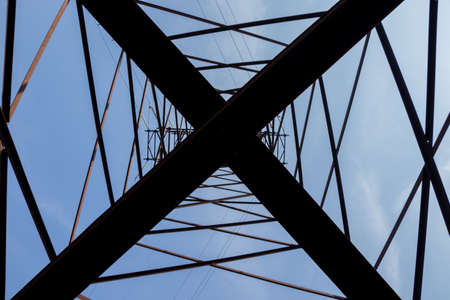 High-voltage tower against the blue sky. High voltage power lines.の写真素材