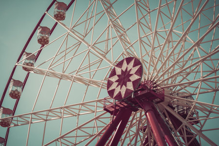 Ferris wheel with blue sky in the background. Retro style effect
