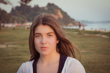 Portrait of a pretty teenage girl outdoor at sunset. Toned effectの写真素材