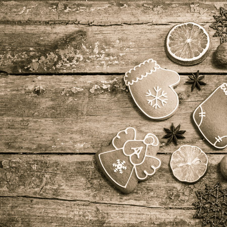 Winter composition with gingerbread cookies, pine cones,  spices, slices of dried citrus fruits and...