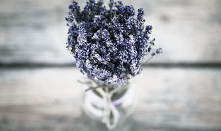 Bouquet of dried lavender on an old painted wooden background close upの写真素材